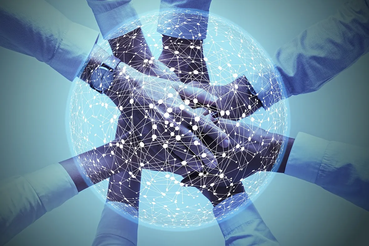 A finance team joining hands over a connected network — the people who send and approve invoices every day